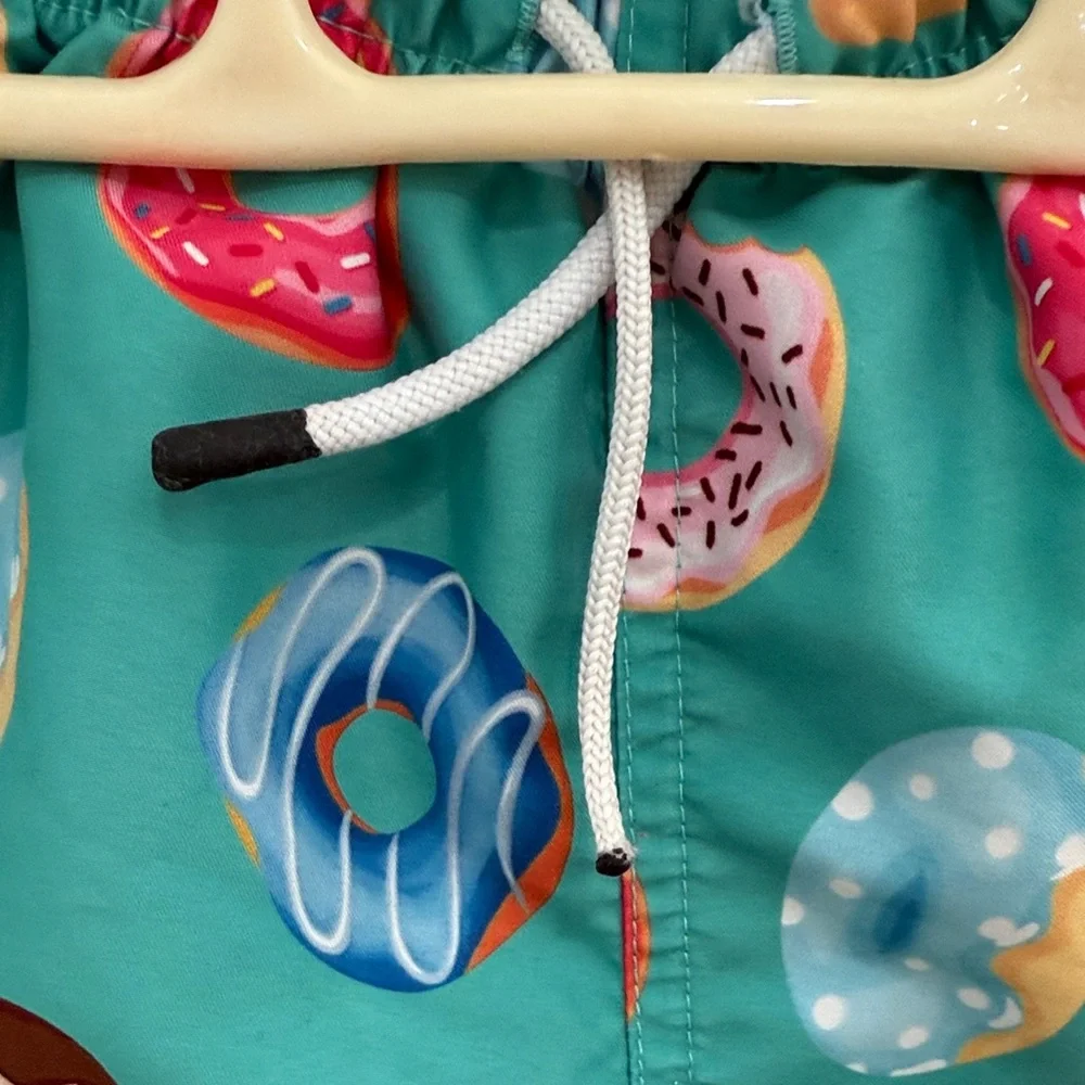 Vibrant Teal Kids Swim Trunks with Donut Design